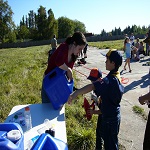 Kayla helps a Scouts refill their water powered vehicles